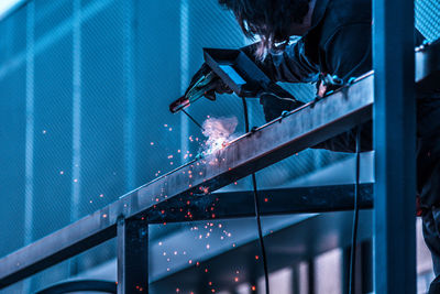 Low angle view of man working at night