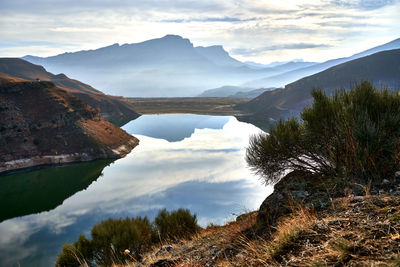 Scenic view of lake and mountains against sky