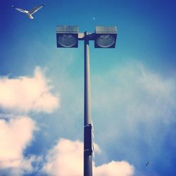 Low angle view of street light against blue sky