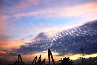 Silhouette of trees against dramatic sky
