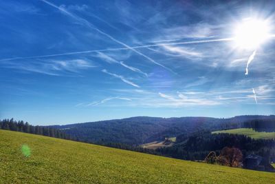 Scenic view of agricultural field against blue sky