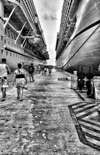 People walking on street in city against sky