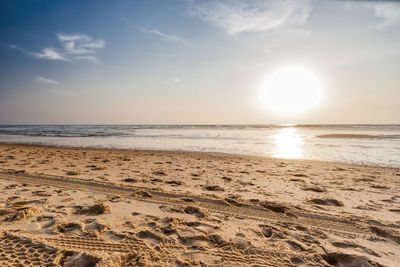 Scenic view of beach against sky during sunset