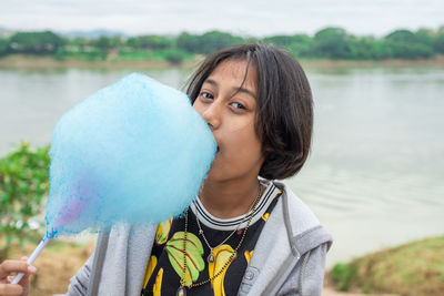 Portrait of a smiling woman holding water