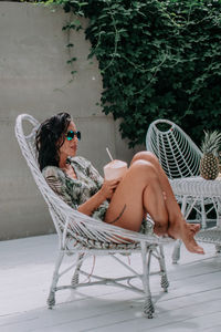 Midsection of woman sitting on chair