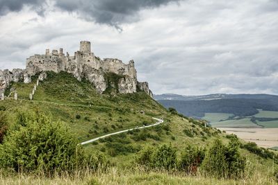 Castle on mountain against sky