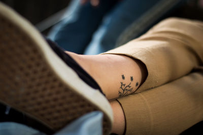 Low section of woman with tattoo