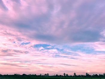 Scenic view of dramatic sky over silhouette landscape