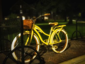Bicycle parked on street at night