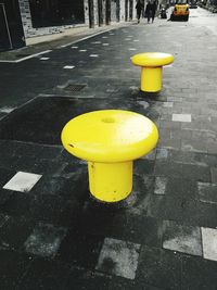 Close-up of yellow arrow symbol on road