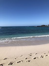Scenic view of sea against clear blue sky