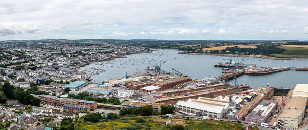 High angle view of townscape by sea against sky