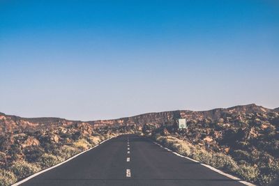 Country road leading towards mountains