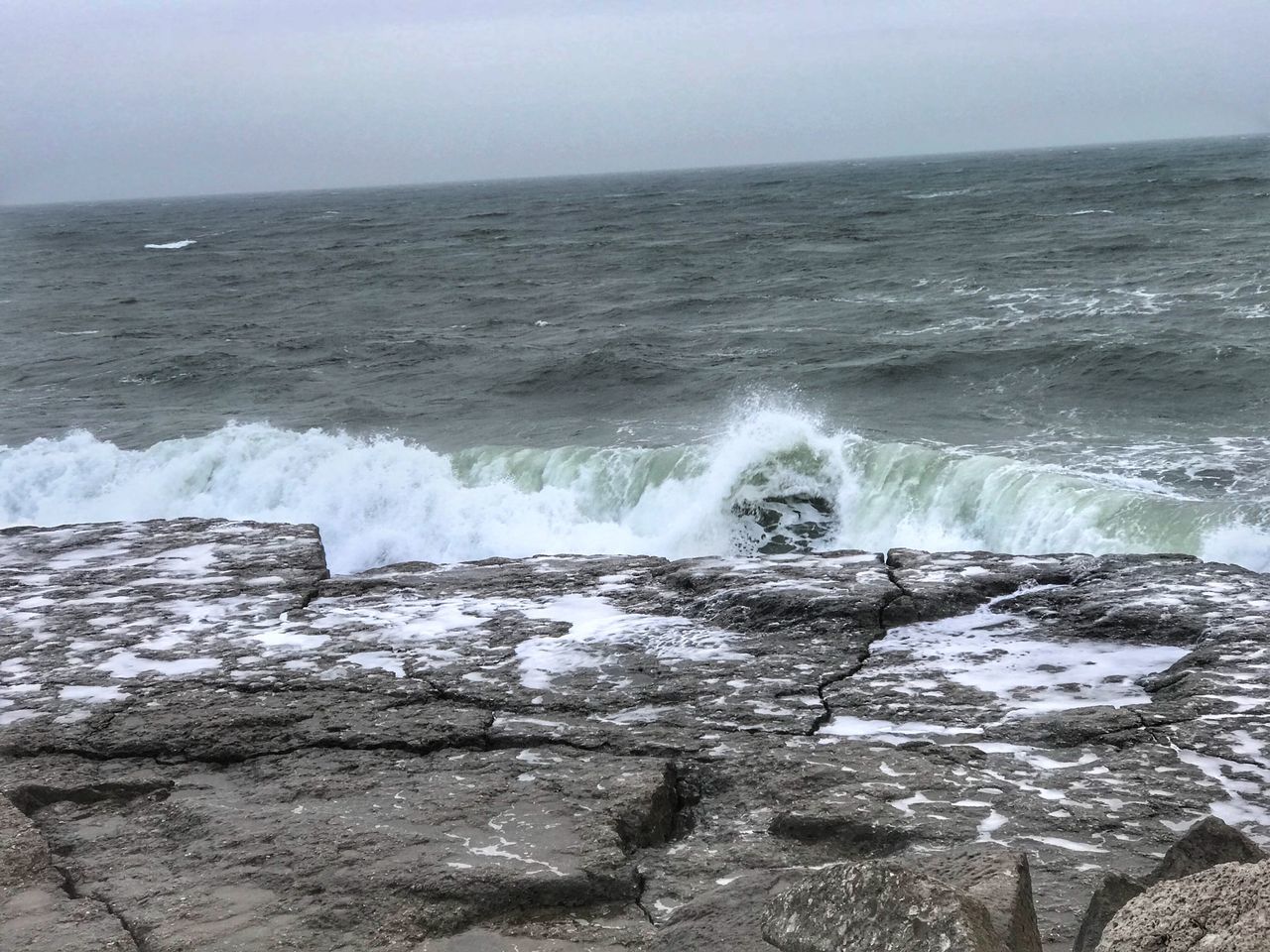 WAVES BREAKING AGAINST SEA