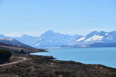 Scenic view of snowcapped mountains against clear blue sky