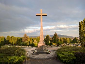 View of cross against cloudy sky