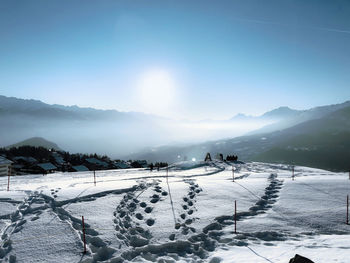 Scenic view of snow covered mountains against sky