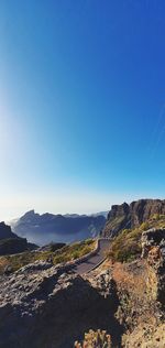 Scenic view of mountains against clear blue sky