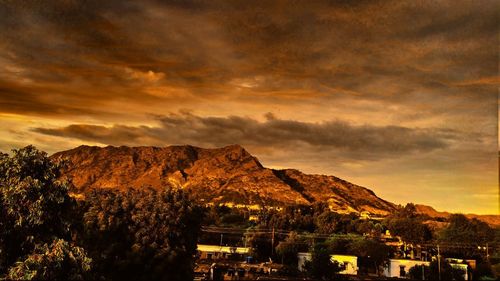 Scenic view of mountains against sky at sunset