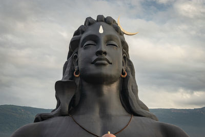 Low angle view of statue against cloudy sky