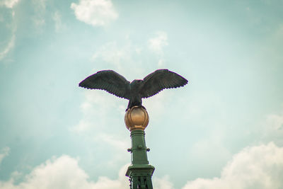 Low angle view of statue against cloudy sky