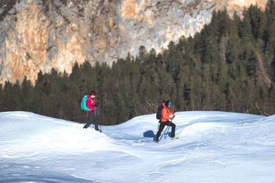 People skiing on snow covered mountain