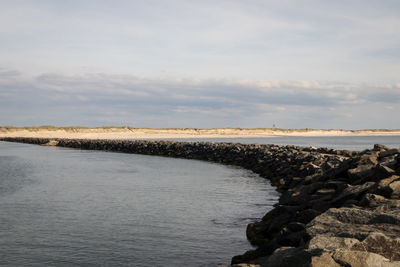 View of calm sea against cloudy sky