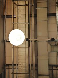 Low angle view of illuminated pendant light on building