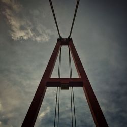 Low angle view of suspension bridge against sky