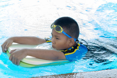 Portrait of boy swimming in pool