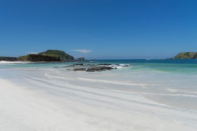 View of beach against blue sky