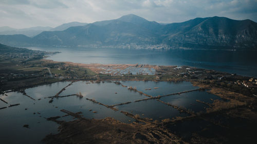 Scenic view of lake by mountains against sky