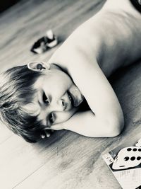 Portrait of cute baby lying on floor at home