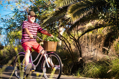 Smiling senior man riding bicycle