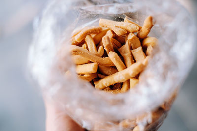 Close-up of hand holding burger