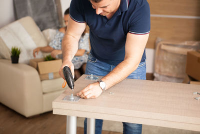 Midsection of man working in workshop