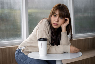 Portrait of woman drinking coffee