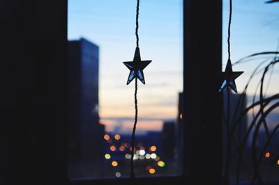 Close-up of silhouette decoration against sky