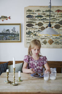 Girl eating by table