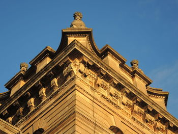 Low angle view of building against clear blue sky