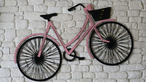 Bicycle wheel against brick wall