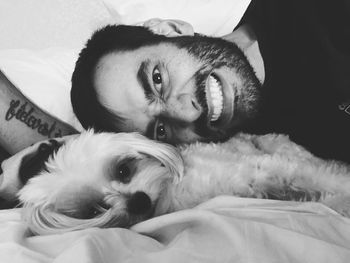 Portrait of dog lying on bed