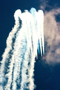 Low angle view of airplane flying against sky