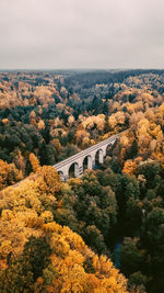 High angle view of arch bridge against sky during autumn