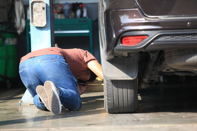 Man sleeping in car on street