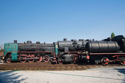 Train on field against clear sky