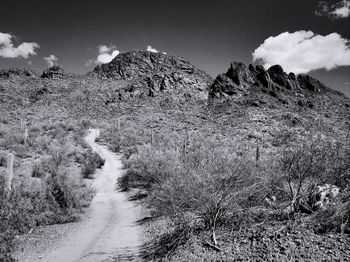 Scenic view of mountains against cloudy sky