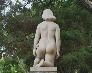 Low angle view of statue against trees in park