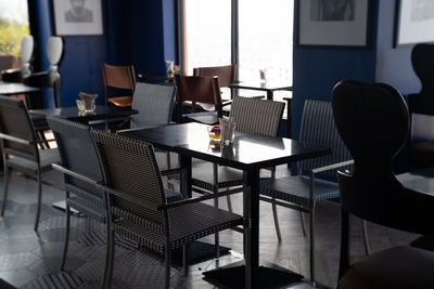 Empty chairs and tables in restaurant