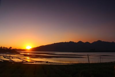 Scenic view of silhouette mountains against sky during sunset